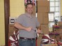 Strongman Andy Duncan inflating basketballs
